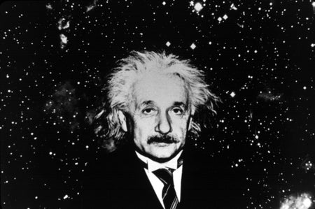 Albert Einstein against starry background, black and white photo
