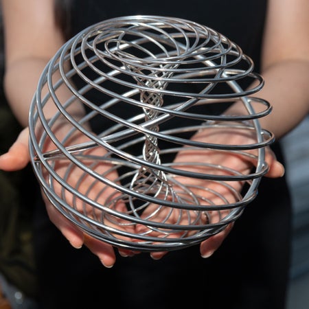 Woman holding metal sphere