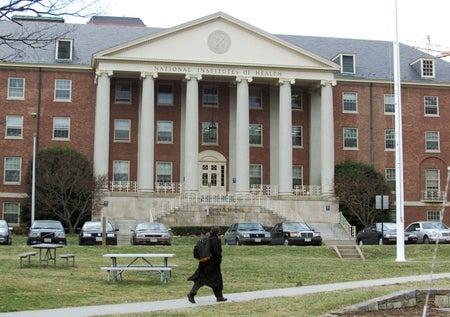 A man walks across the campus of the National Institutes of Health in Bethesda, MD.