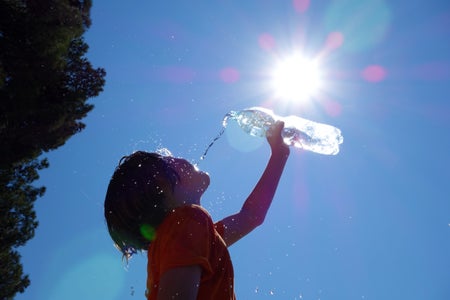 Child in heatwave with water bottle