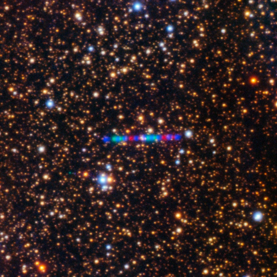 Comet 3I/ATLAS streaks across a dense star field in this image captured by the Gemini North telescope's Gemini Multi-Object Spectrograph (GMOS-N). The image was composed of exposures taken through three filters, shown here as red, green, and blue.