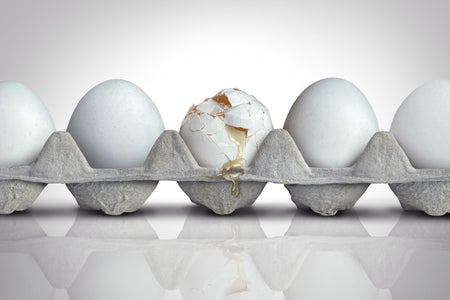 Carton of eggs with one cracked egg