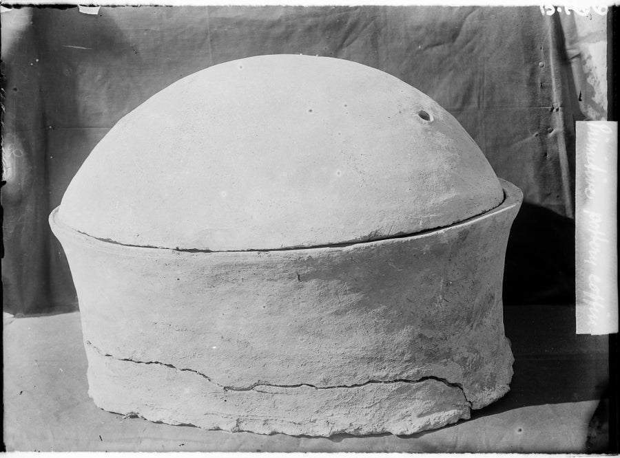 Black and white photograph of a tapered cylindrincal pot with a domed lid