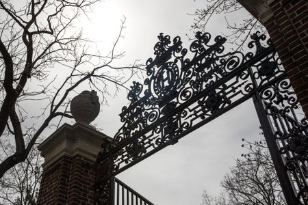 A gate stands in front of Harvard Yard on the closed Harvard University campus in Cambridge, Massachusetts, U.S., on Monday, April 20, 2020.