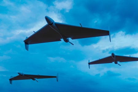 Illustration of three Shahed-136 drones in Russian service flying in triangle formation, view from below against a cloudy sky at dusk