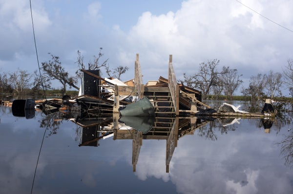 A house destroyed by a hurricane submerged in floodwater