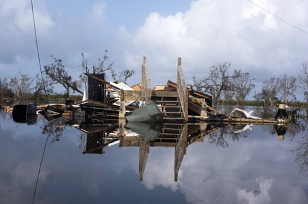 A house destroyed by a hurricane submerged in floodwater