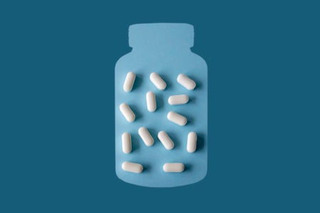 Cut-out pill jar shape with white capsules inside