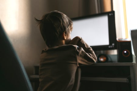 Little boy sits at a computer, online training during quarantine, distance learning