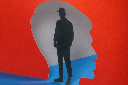 Paper craft illustration of silhouette of human head with male figure standing inside
