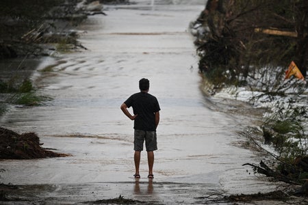 Silhouette of man surveying flood damage