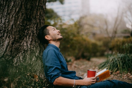 Man having a coffee break at park in city