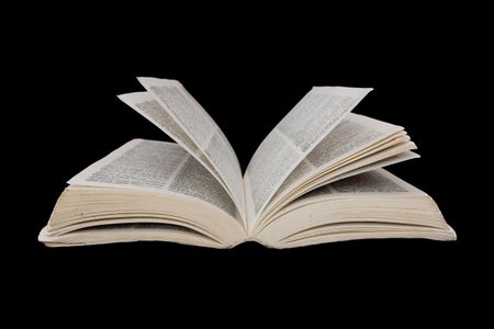 Open dictionary on black background