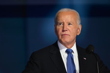 President Joe Biden portrait with blue tie and blue background.
