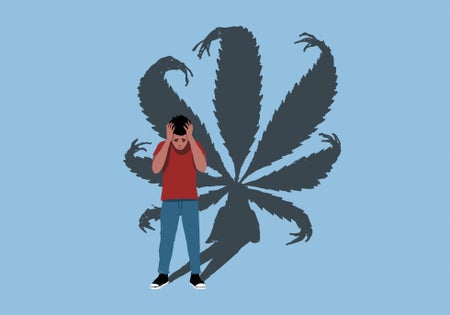 Person holding head in hands with large cannabis leaf shadow in background