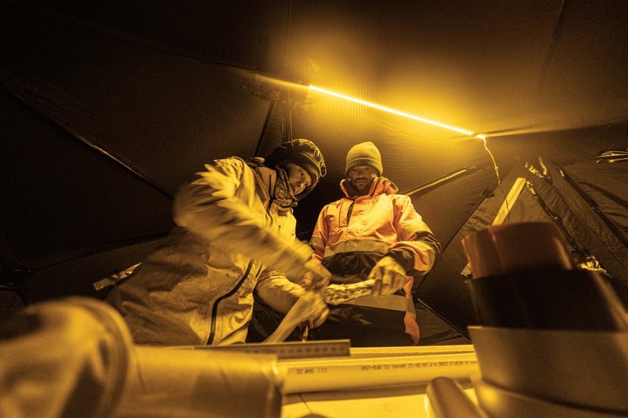 Image of scientists in blacked out tent