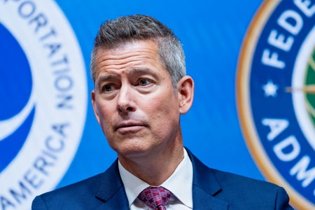 Sean Duffy, US secretary of transportation, during a news conference, standing in front of the seals for the Department of Transportation and Federal Aviation Administration