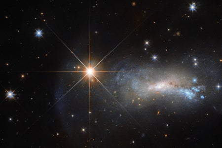The bright object seen in this Hubble image is a single and little-studied star named TYC 3203-450-1, located in the constellation of Lacerta (The Lizard). The star is much closer than the much more distant galaxy seen in the background named NGC 7250.