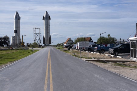 SpaceX rocket at end of a neighborhood street in the company’s Starbase launch complex
