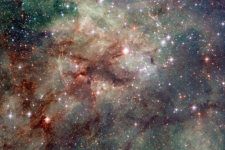 Nebula filled with bright stars, glowing clouds in shades of green, blue and maroon