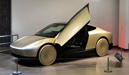 Gold Tesla cybercab with raised door