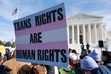 "Trans Rights Are Human Rights" sign at rally outside Supreme Court building