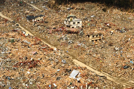 Aerial view of flattened buildings and scattered debris