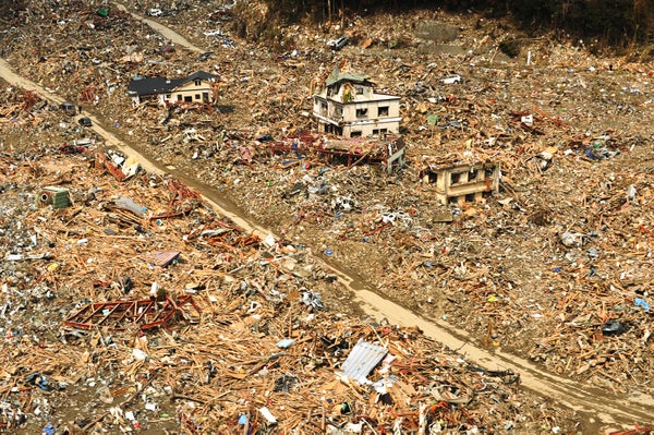 Aerial view of flattened buildings and scattered debris