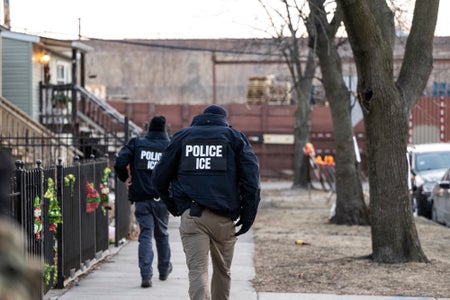 US Immigration and Customs Enforcement (ICE) agents walk down a street during a multi-agency targeted enforcement operation in Chicago, Illinois, US, on Sunday, Jan. 26, 2025.