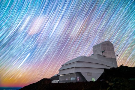 Countless star trails appear as colorful brushstrokes spread across the night sky above NSF–DOE Vera C. Rubin Observatory